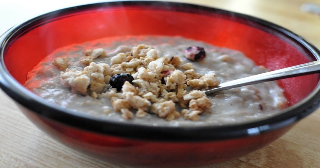 A bowl of granola mixed with yogurt and berries.