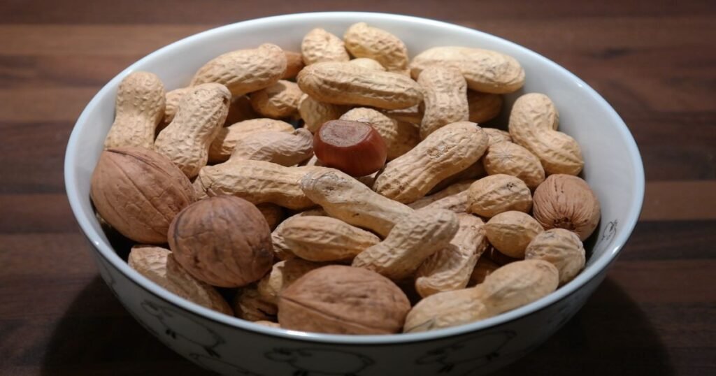 A variety of nuts including almonds, walnuts, and cashews in a bowl.