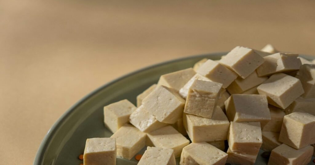 Grilled tofu slices served on a plate with vegetables.