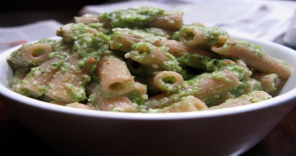 A plate of whole wheat pasta topped with herbs.